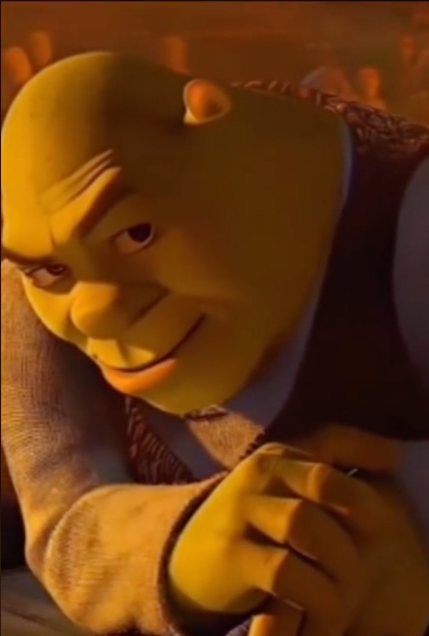 Shrek looking at you while smiling.